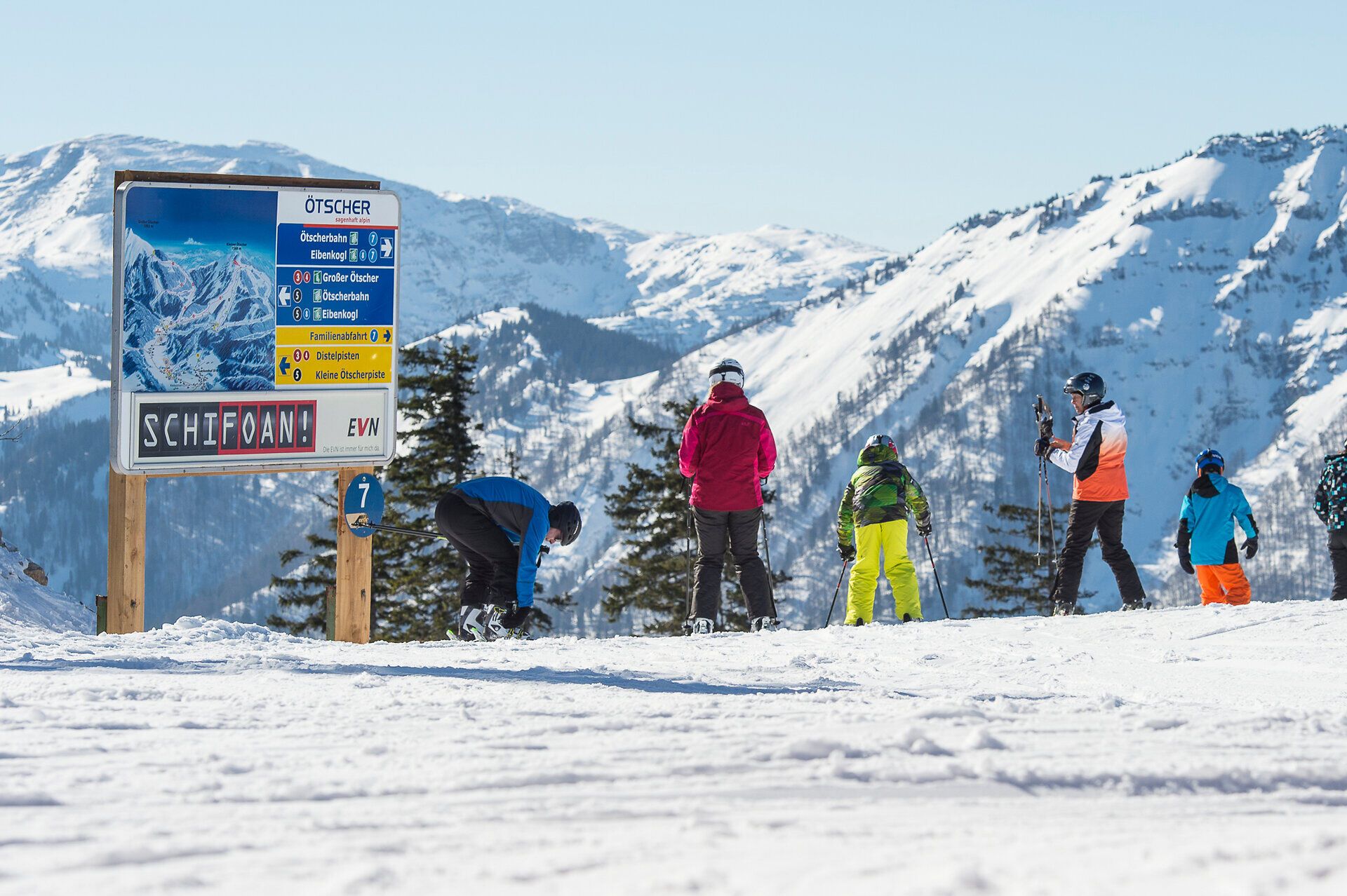 Die strahlende Wintersonne taucht die schneebedeckten Berge in ein warmes Licht, während begeisterte Skifahrer sich auf die Pisten begeben. Die frische, klare Luft und die majestätische Kulisse laden zu unvergesslichen Abenteuern im Schnee ein.